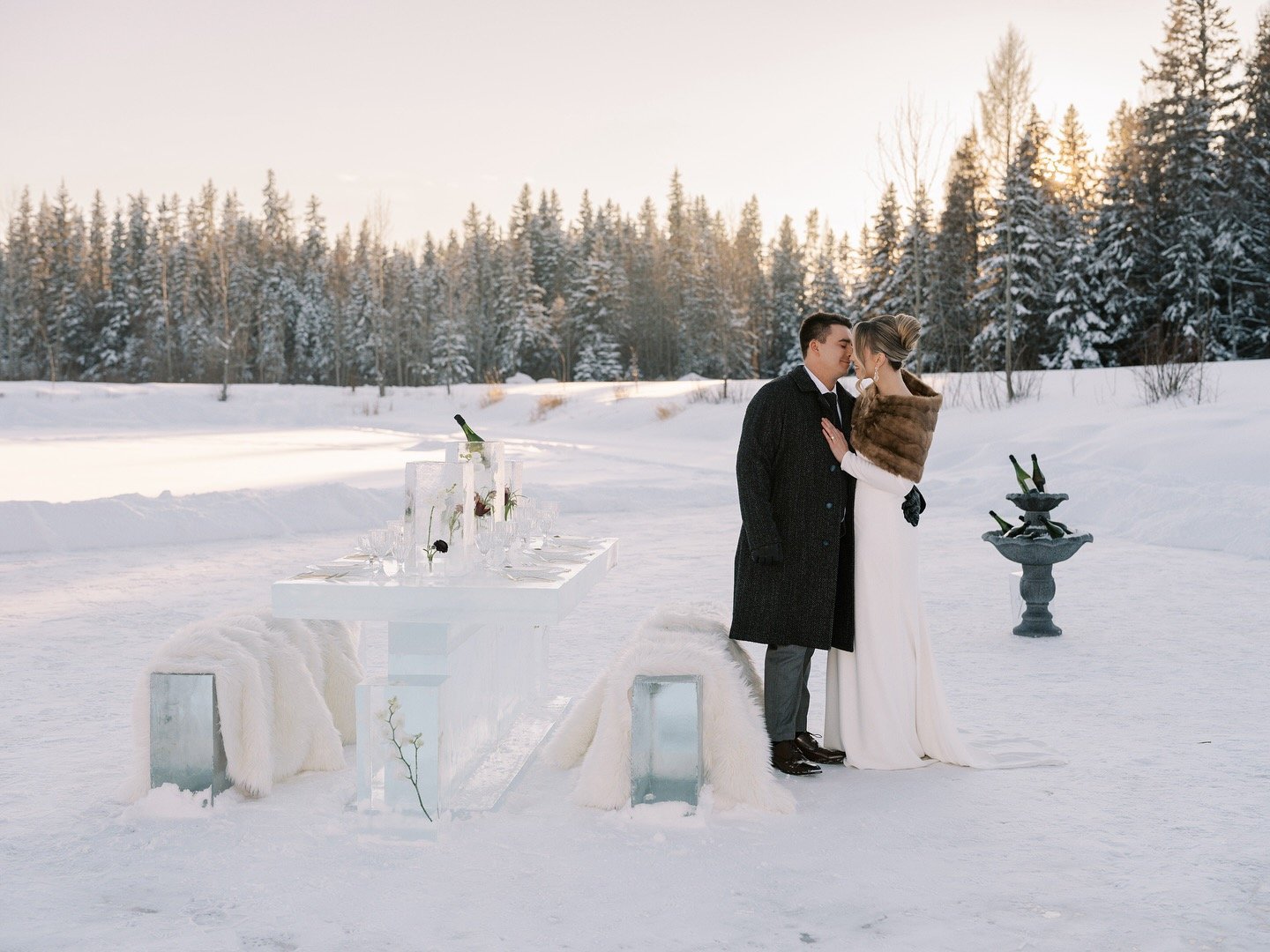 Couple seated at the ice table at sunset
