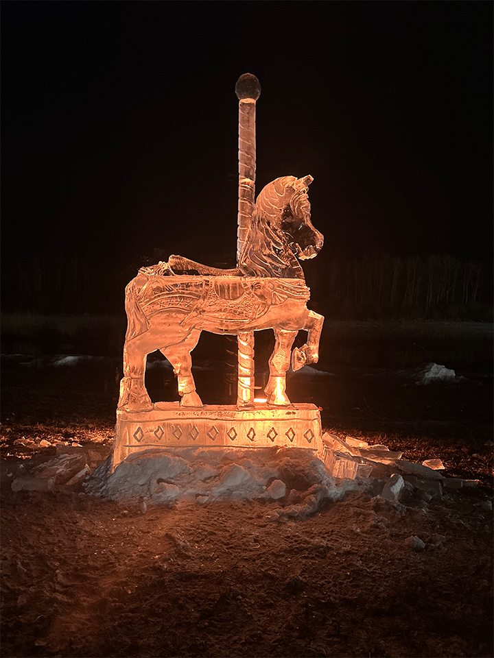 Carousel horse ice sculpture at night