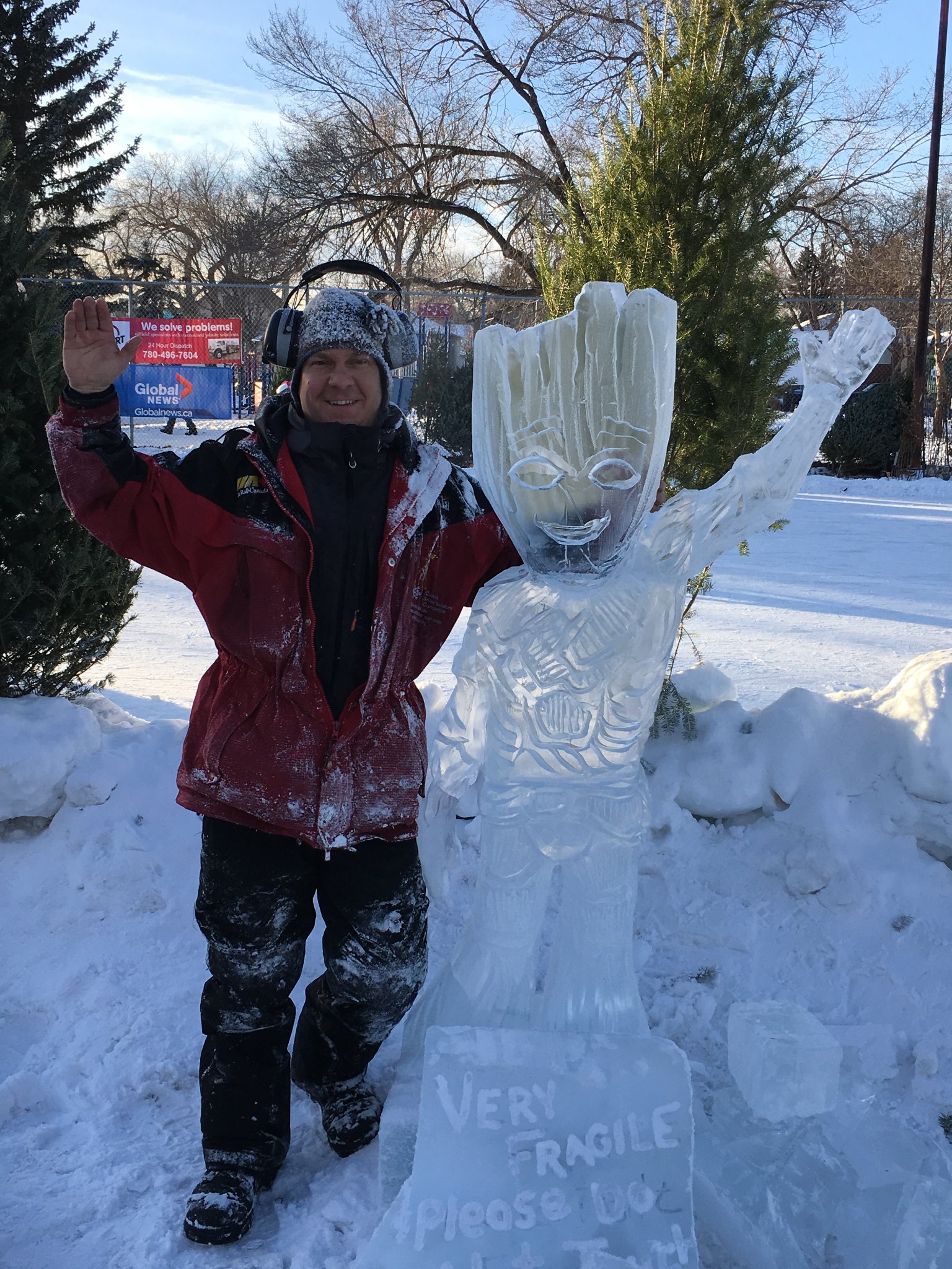 Sculptor posing with Baby Groot ice sculpture