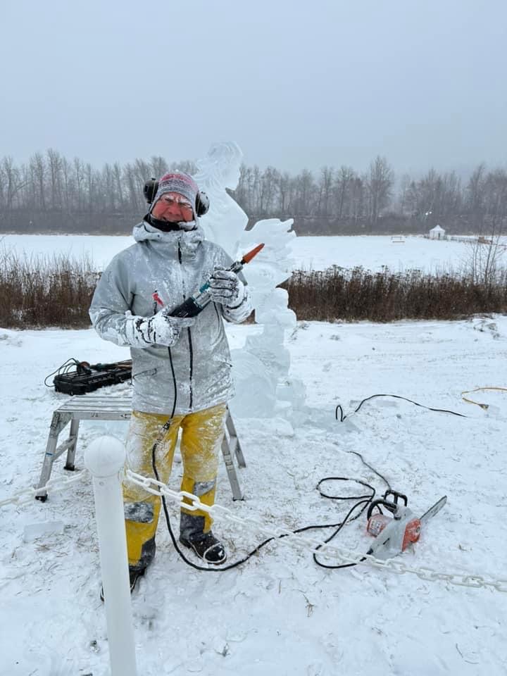 Sculptor with mermaid ice sculpture in Fort McMurray