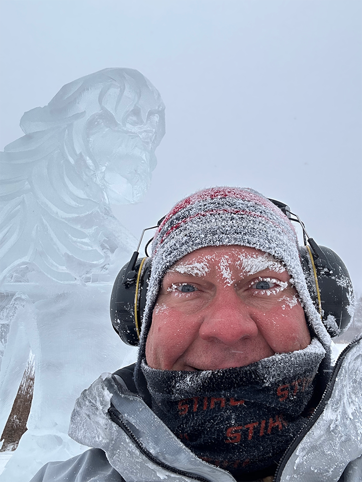 Sculptor with warrior princess ice sculpture in fog
