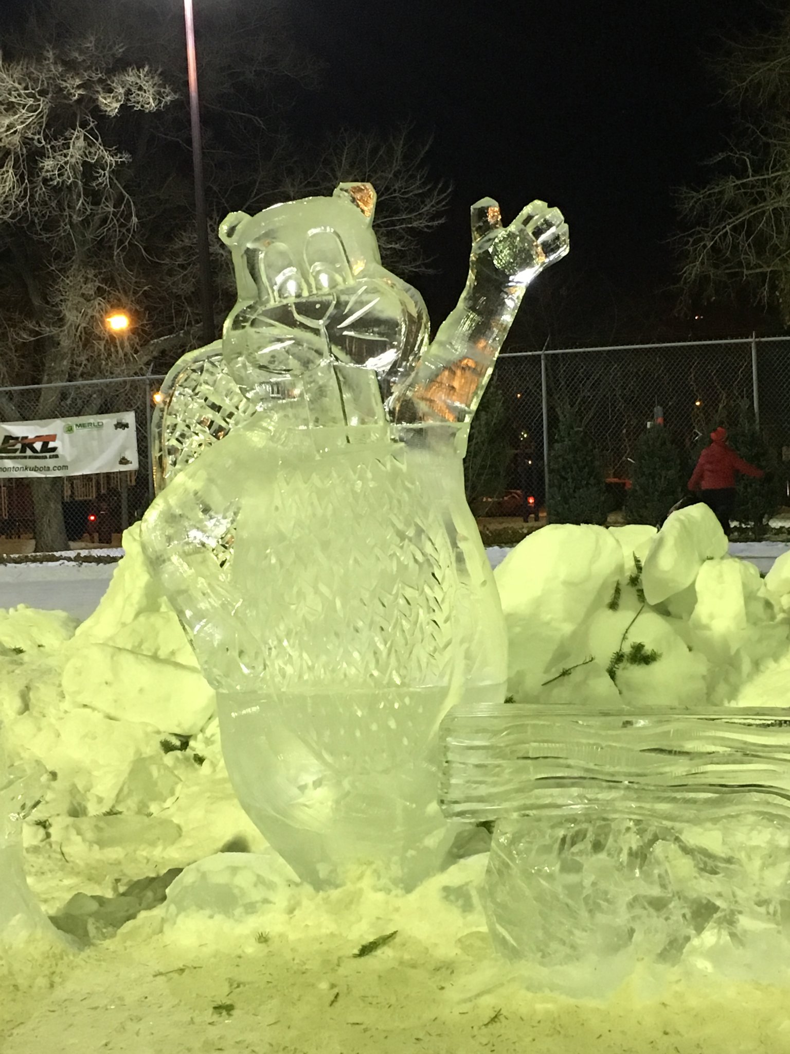 Waving beaver ice sculpture at night